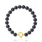 un bracelet en perles noires avec un fermoir en or