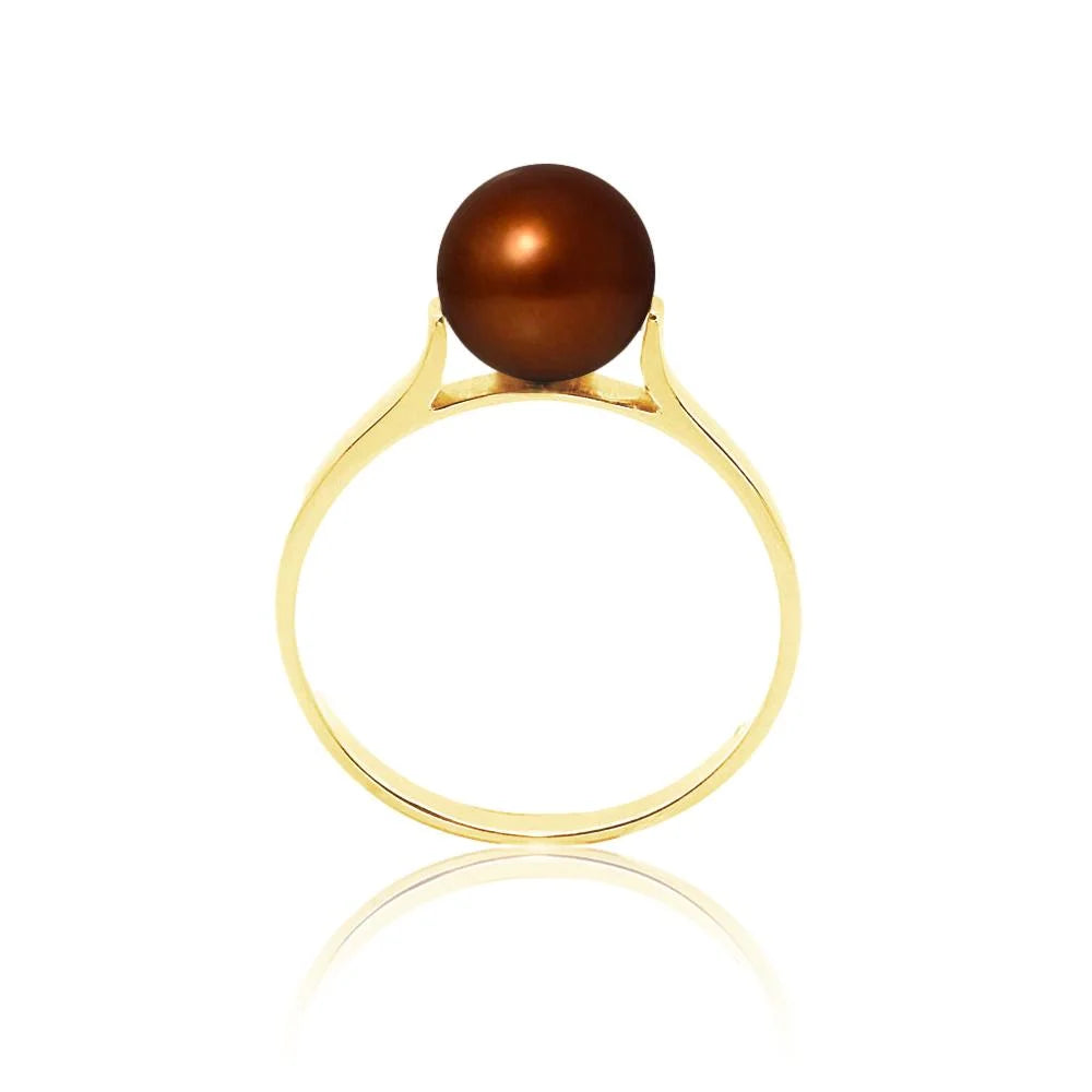 une bague en or avec une perle brune