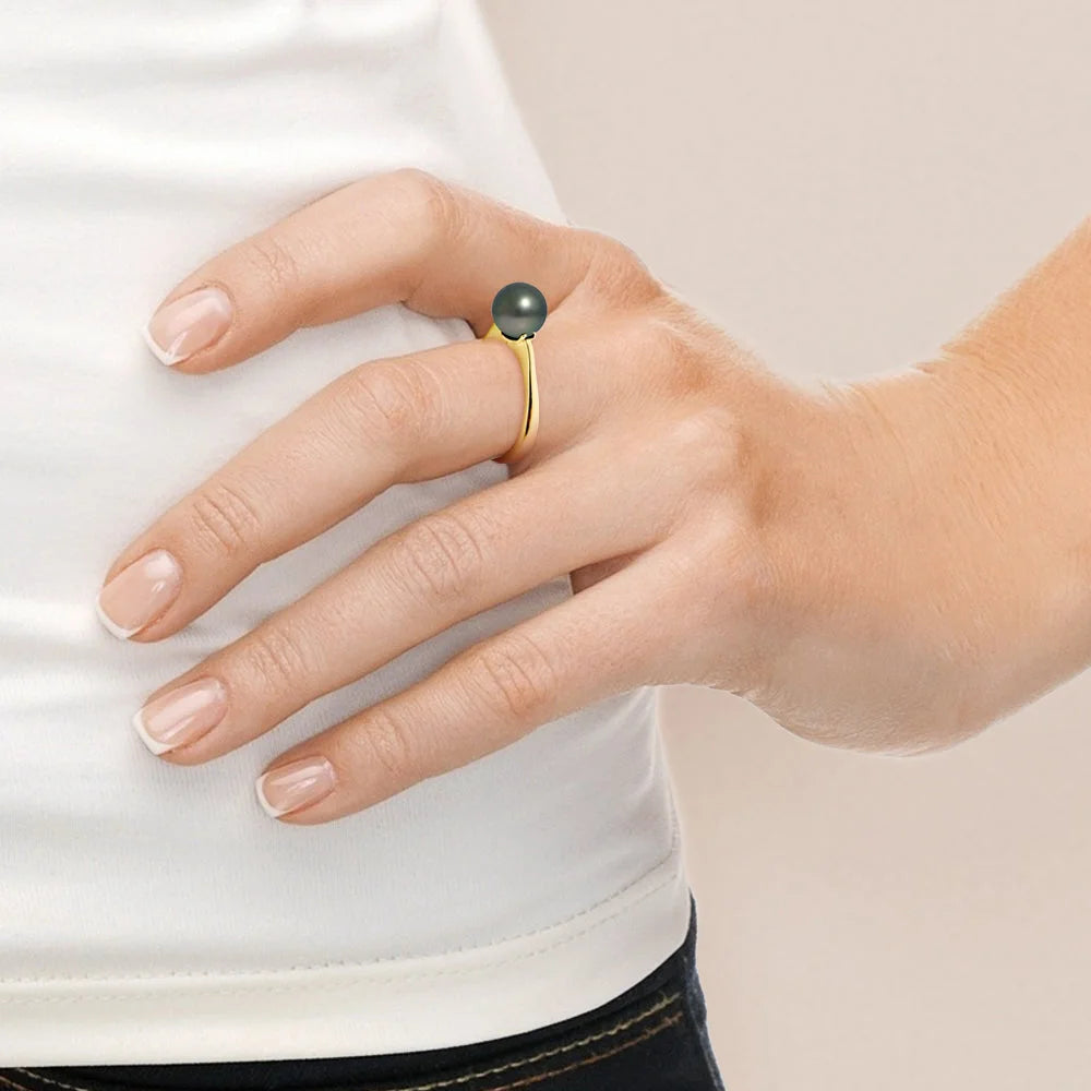 une femme portant une bague avec une pierre verte