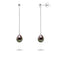 une paire de boucles d’oreilles en perles noires