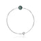 un bracelet avec une perle verte et une boule en argent