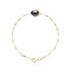 un bracelet en perles noires et or