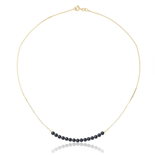 un collier de perles noires avec une chaîne en or