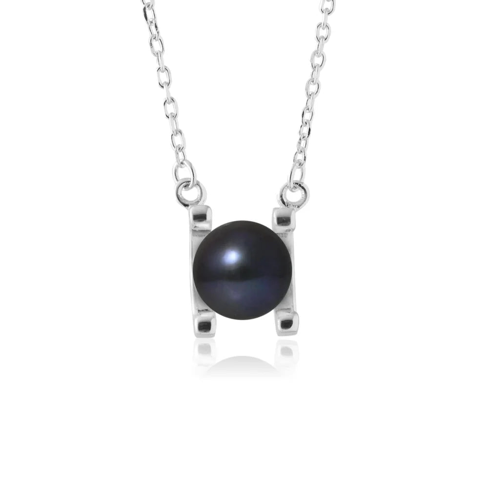 un pendentif en perle noire sur une chaîne en argent